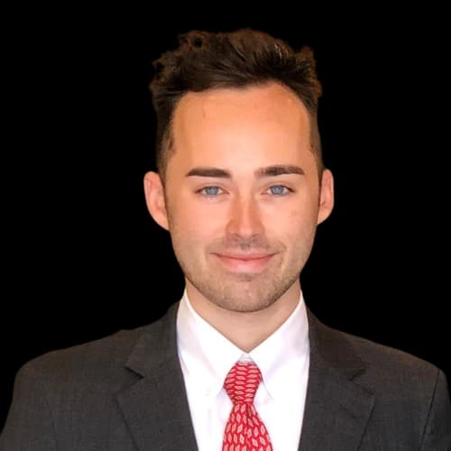 Preston Jenkins smiling with a cityscape background